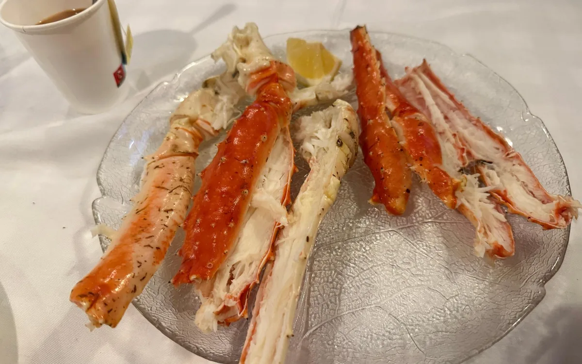 A platter of split king crab legs served with lemon and butter