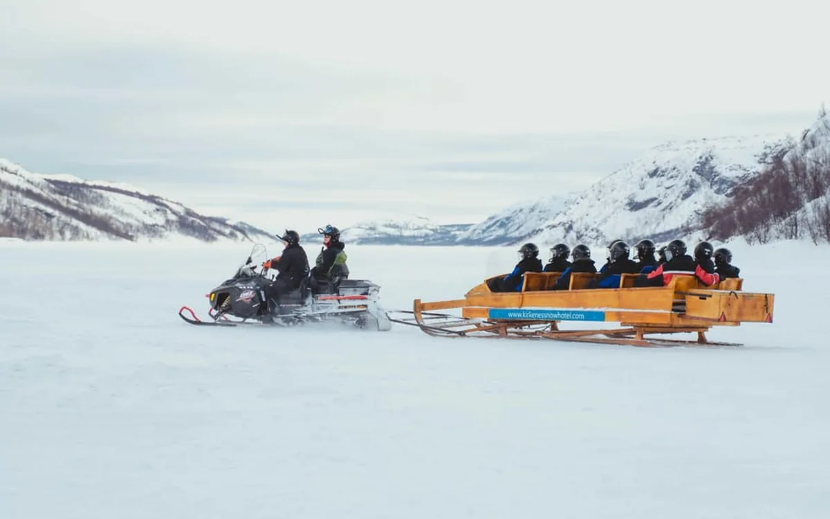 A snowmobile sled crossing the frozen fjord